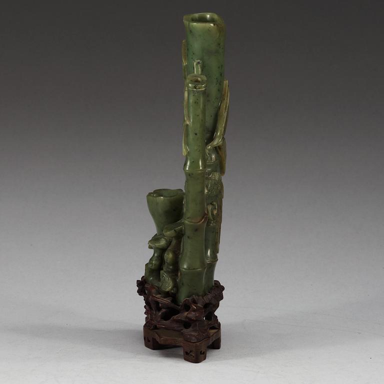A  carved green stone sculpture, late Qing dynasty.