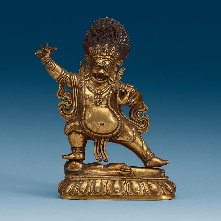 A Sinotibetan gilt bronze figure of a Dharmapala, Qing dynasty, 19th Century.