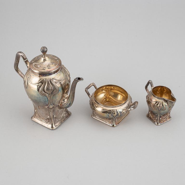 An art nouveau silver coffee pot, sugar bowl and creamer, mark of CF Källström, Malmö 1901.