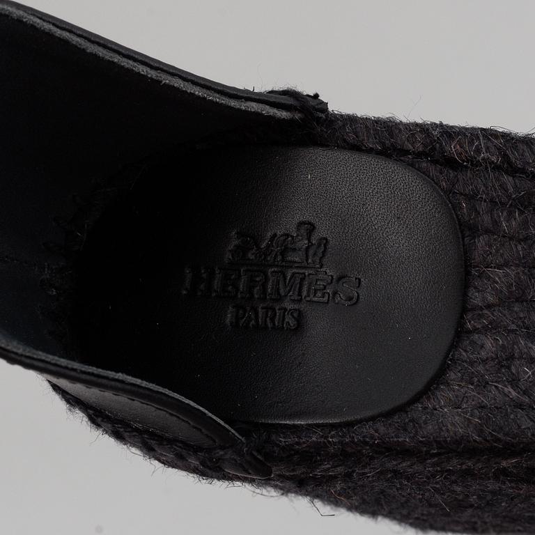 HERMÈS, a pair of black leather 'Tivoli' wedge sandals, 2019, size 38.