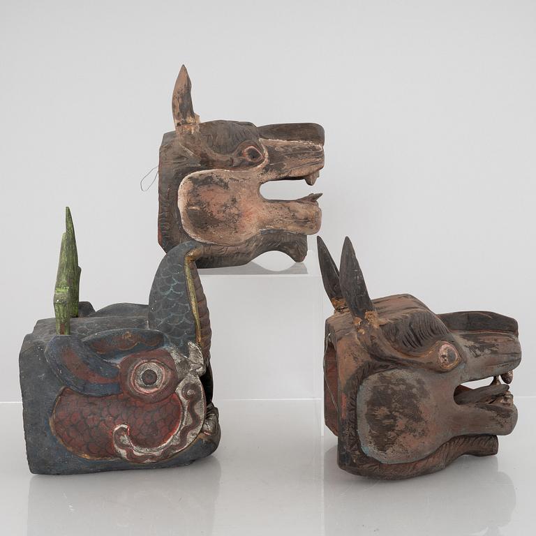 Four Tibetan/South East Asian wooden decorations, 20th century.
