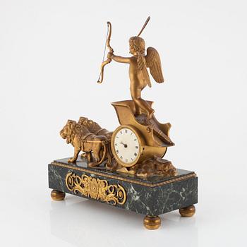 An Empire-style gilt-bronze and verde antico 'Au char de l'Amour' figural mantel clock, late 19th century.