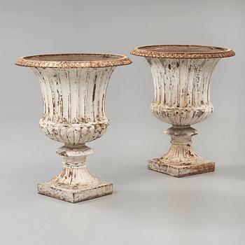 A pair of English 1860's iron garden urns.