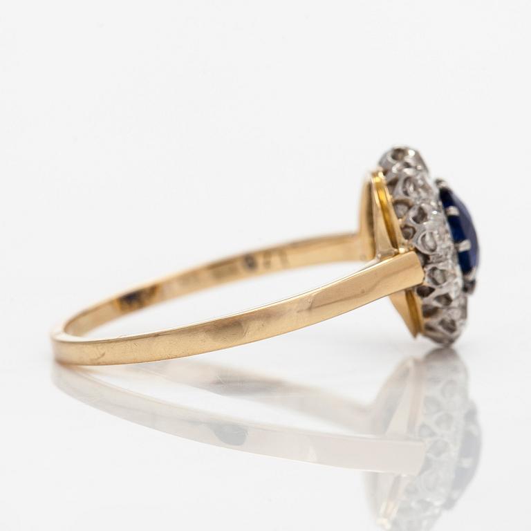 An 18K gold ring, with a sapphire and old-cut diamonds.