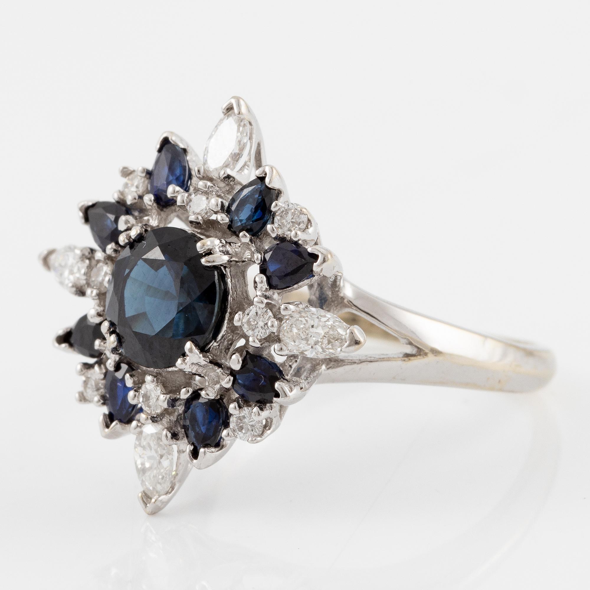 Ring 18K white gold with dark sapphires, pear-shaped and brilliant-cut diamonds.