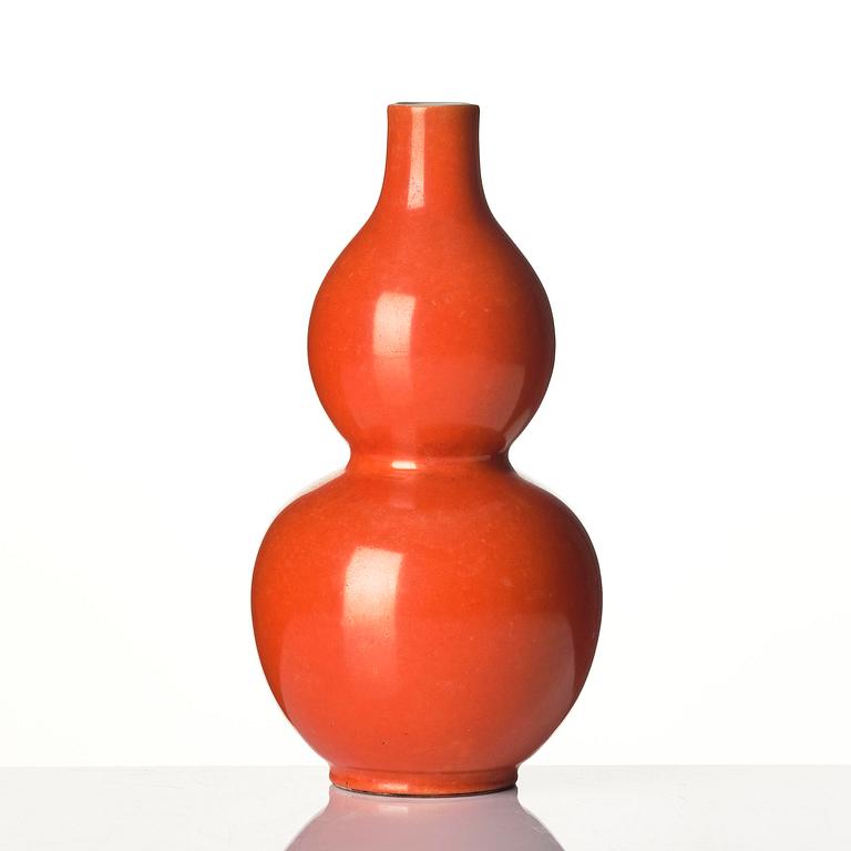 A coral red-enameled double-gourd vase, Qing dynasty with Jiaqing mark (1796-1820).