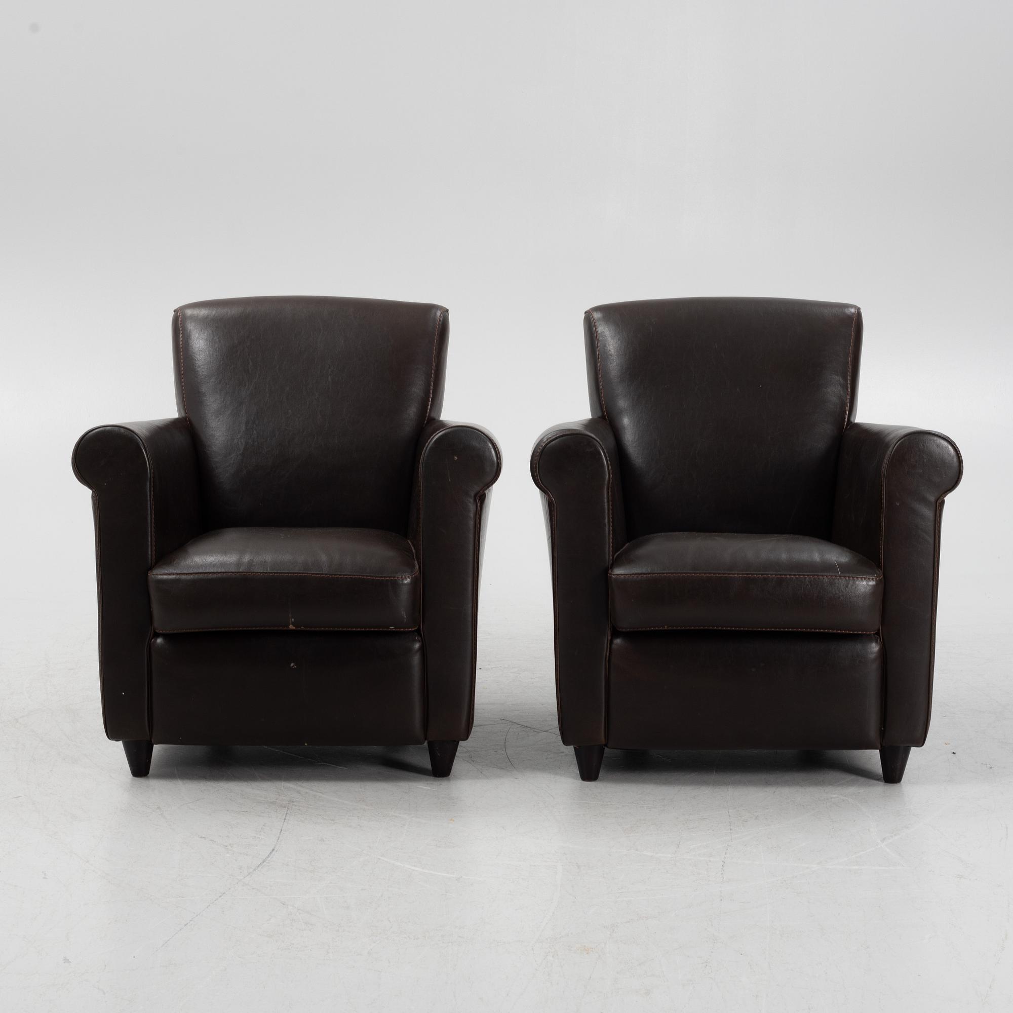A pair of leather upholstered easy chairs, end of the 20th Century.
