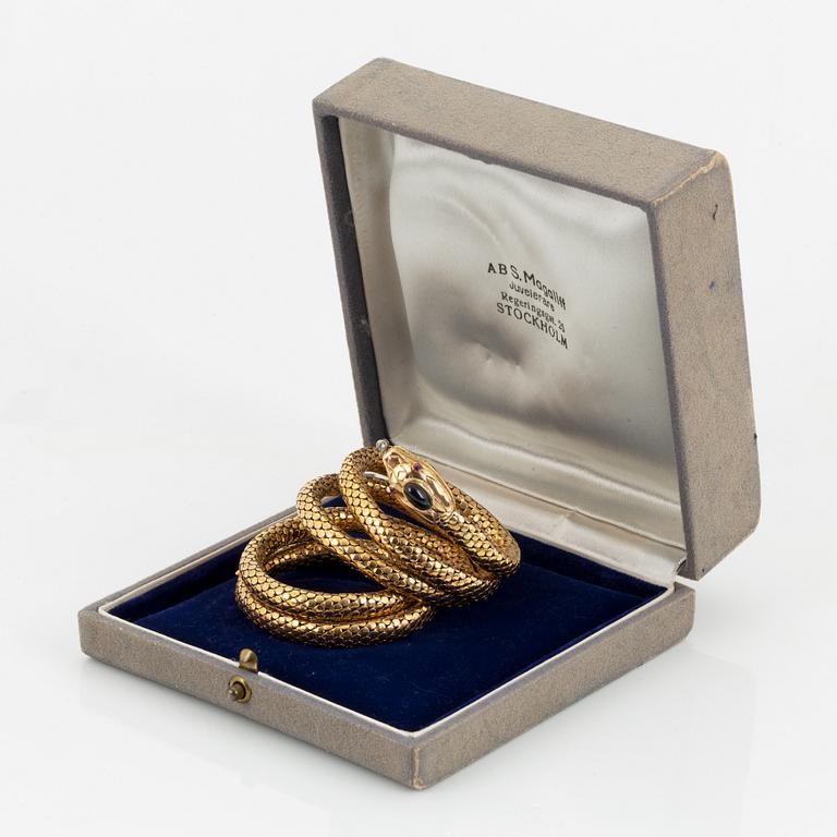 An 18K gold snake bracelet.