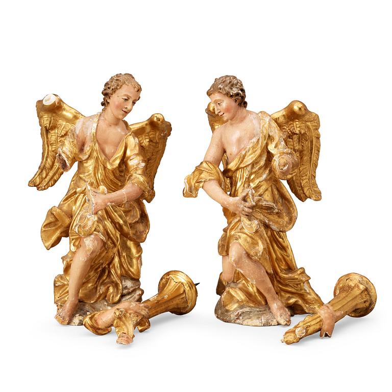 A pair of wooden candleholding angels, around year 1800.