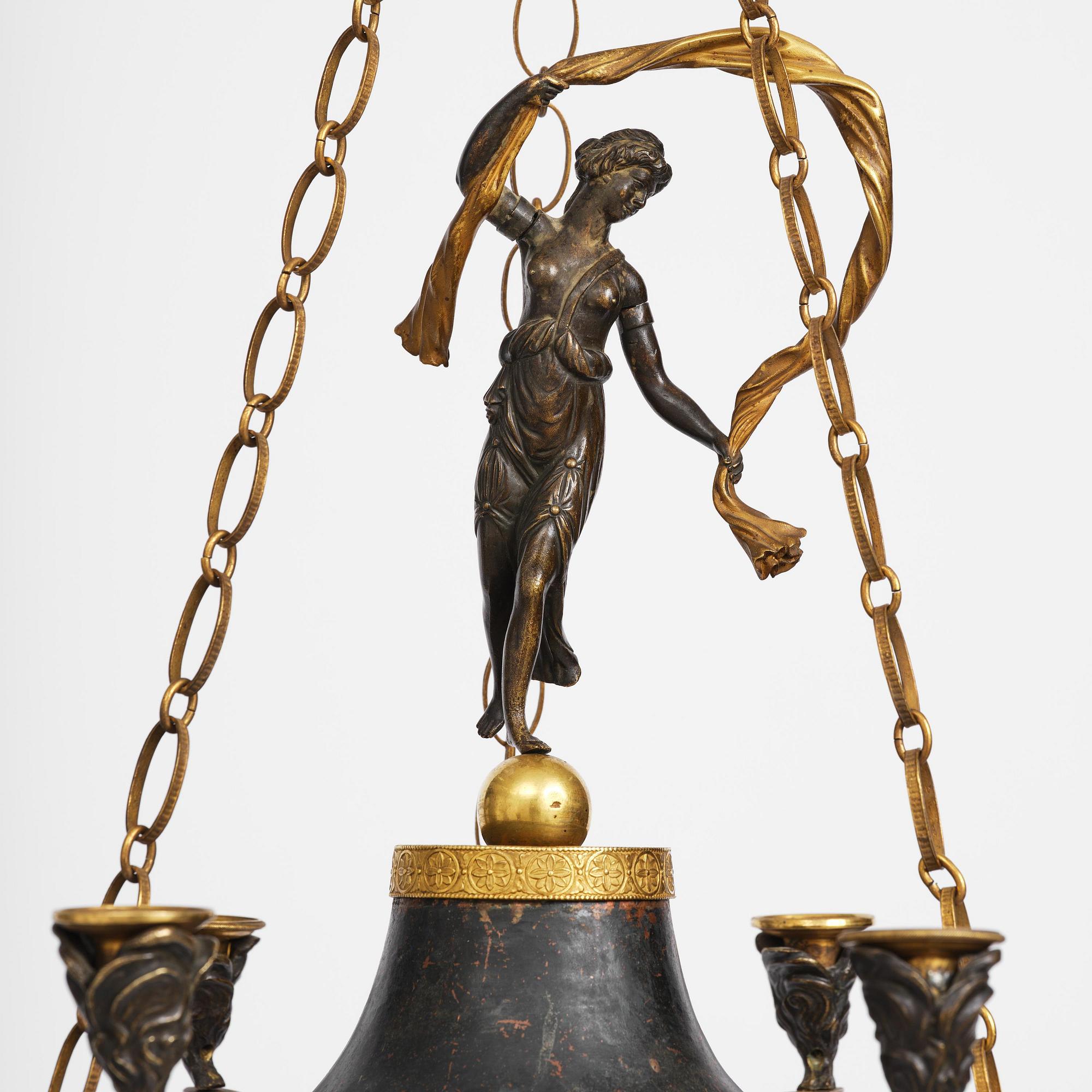 A patinated and ormolu six-light Empire chandelier, Stockholm, first part 19th century.