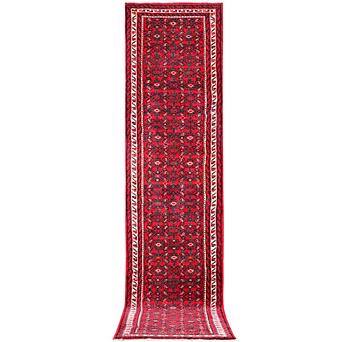 An oriental runner carpet, c. 395 x 87 cm.