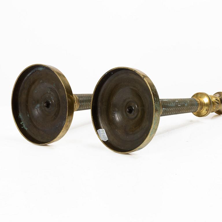 A pair of French Empire ormolu candlesticks, early 19th century.
