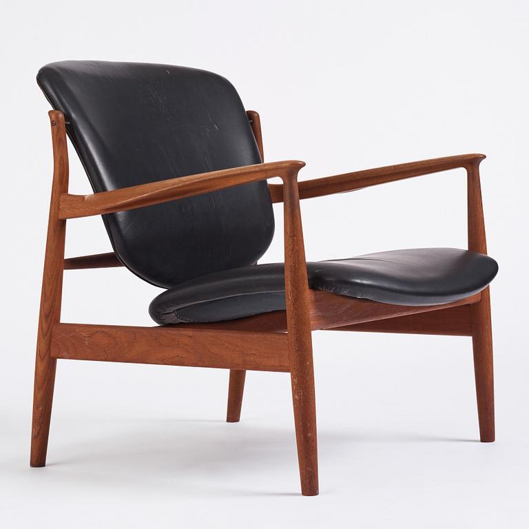 Finn Juhl, a teak and black leather 'model 136' easy chair, France & Daverkosen, Denmark 1950-60s.