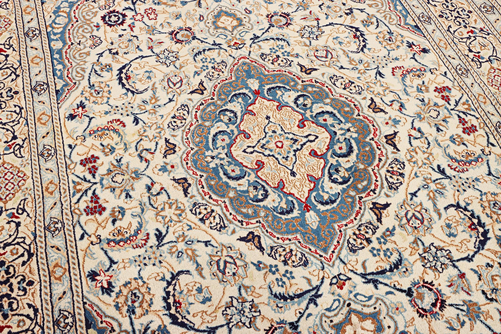 A Nain carpet, part silk, 9 laa, c. 300 x 195 cm.