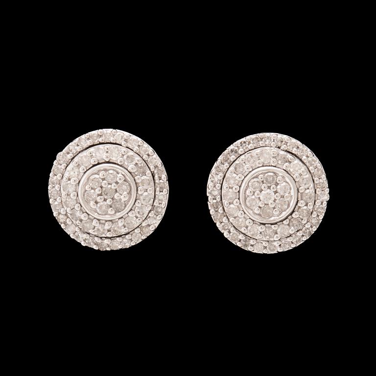 A pair of 14K white gold earrings set with round single-cut diamonds.