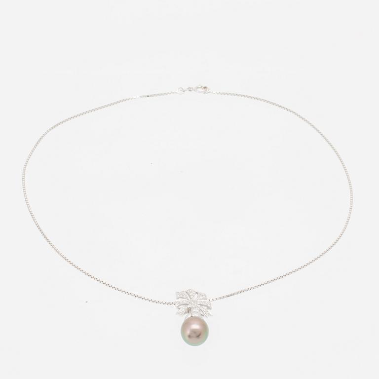 An 18K white gold necklace set with a drop-shaped cultured pearl and round brilliant-cut diamonds.