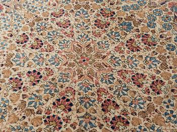 A semi-antique/old Kerman carpet, around 361 x 264 cm.