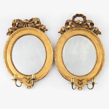 A pair of Gustavian-style giltwood two-light mirror scocnes, 19th Century.