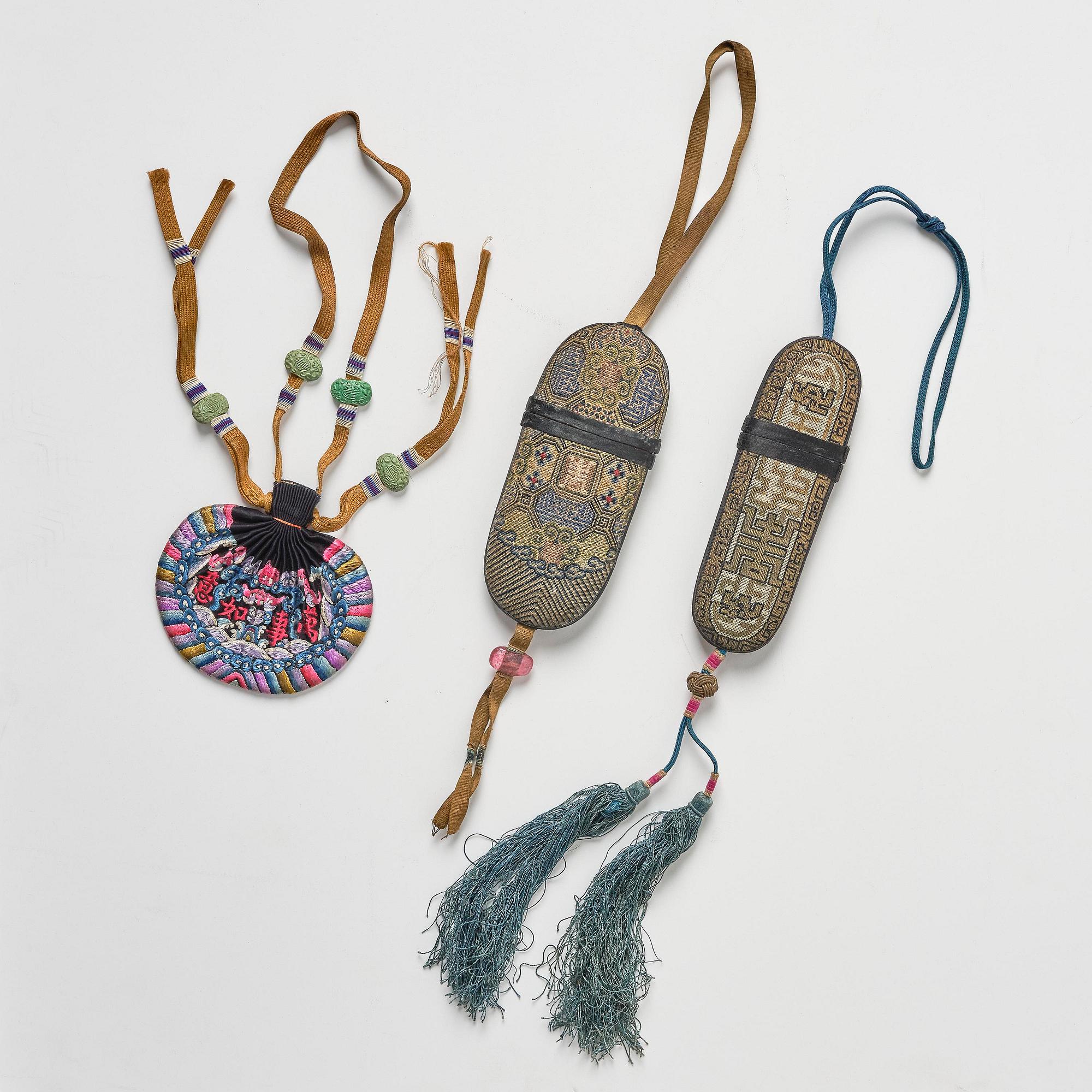 A set of three embroidered purses/ eye-glass cases, Qing dynasty, 19th century.