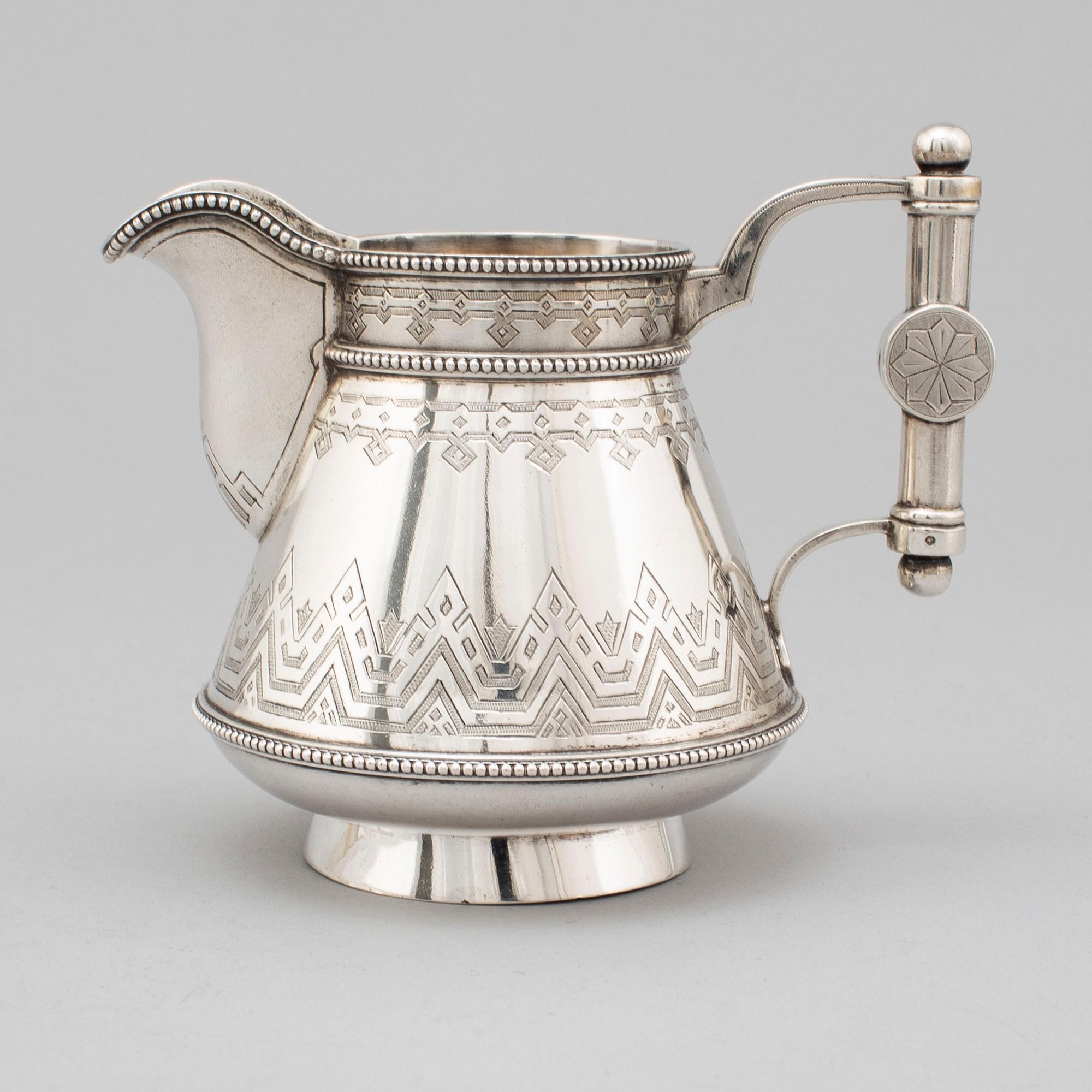 A Russian 19th century parcel-gilt silver tea pot and cream jug, mark possbly of Alexander Lokin, St. Petersburg 1893.