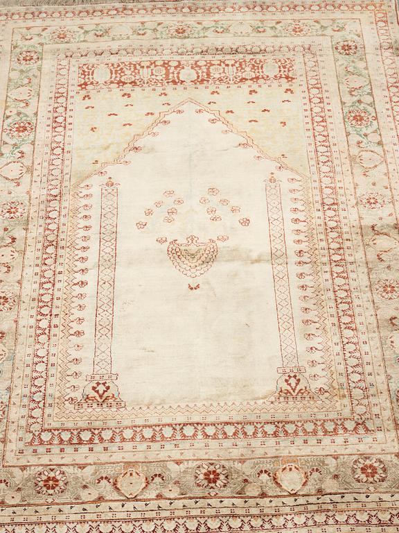 A RUG, an antique silk Tabriz, ca 165 x 118,5-111,5 cm.