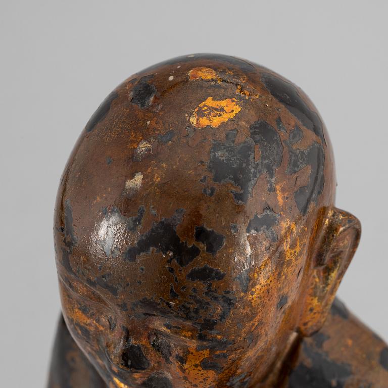 A Chinese wood gilt and lacquer sculpture of a boy, 20th Century.