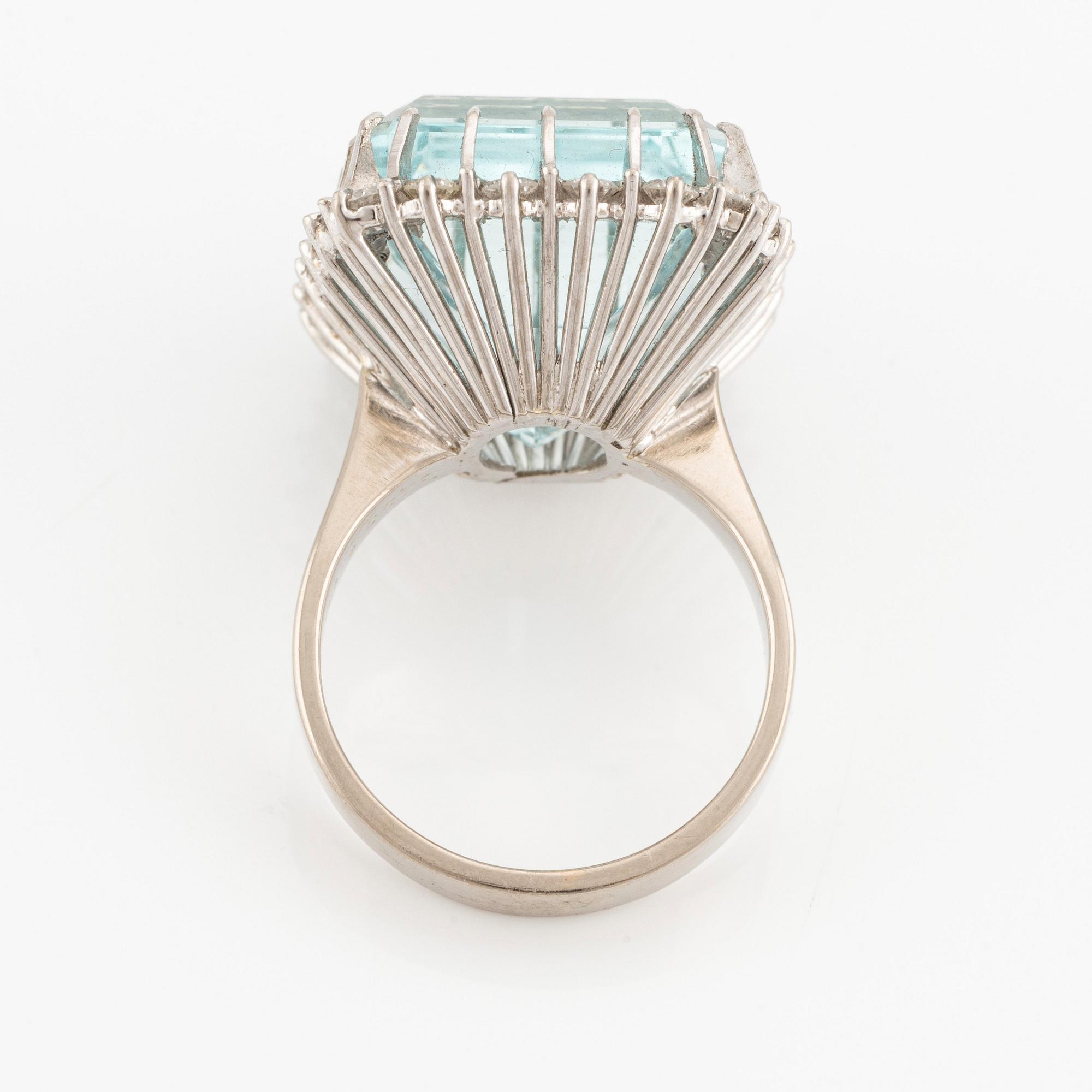 An 18K white gold Engelbert ring set with a aquamarine and round brilliant-cut diamonds.