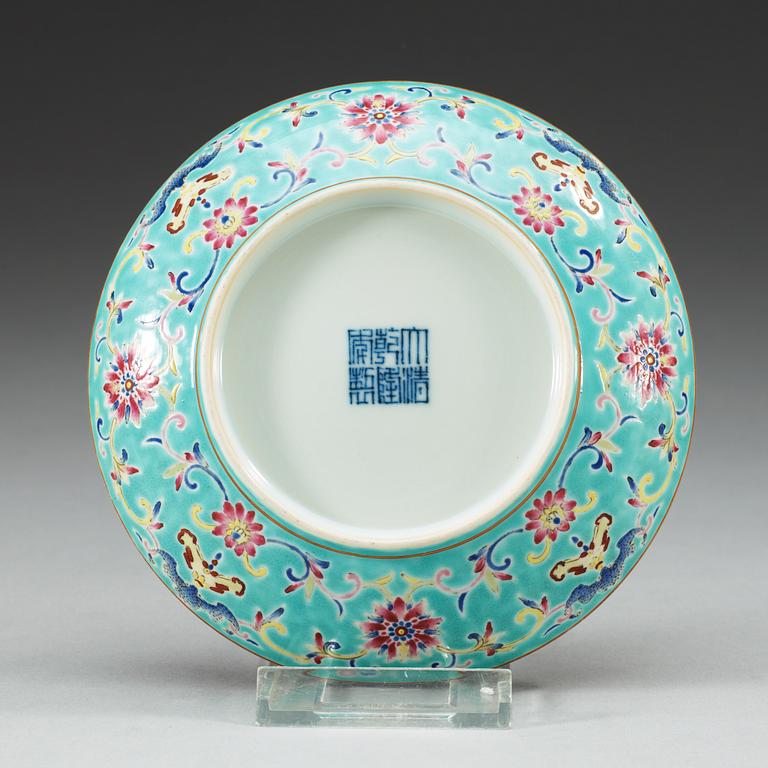 A turkoise ground famille rose dish, Qing dynasty, with Qianlongs seal mark.