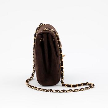 CHANEL, a brown suede shoulderpurse.