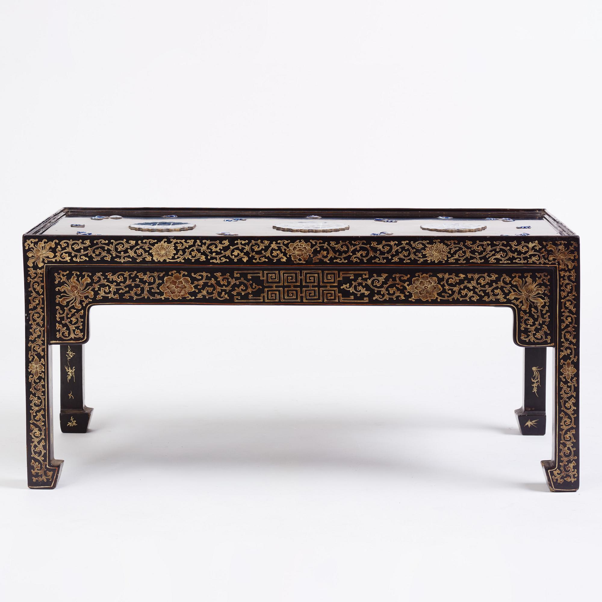 A Chinese black lacquered table with porcelain placques, presumably first half of the 20th century.