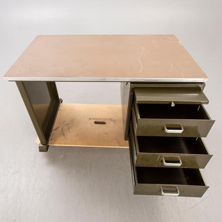 An 1950:s industrial metal and linoleum writing desk.