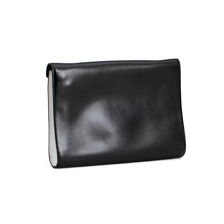 CÉLINE, a black and white leather clutch.