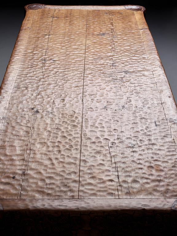 Gustaf Fjaestad, an Art Nouveau carved pine table, Arvika Sweden 1914, a double to the table in the Thiel Collection,