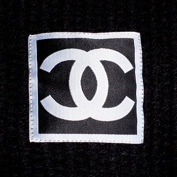 CHANEL, a black cashmere carding and a bouclé skirt.