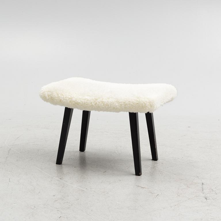 A mid 20th Century stool with sheepskin upholstery.