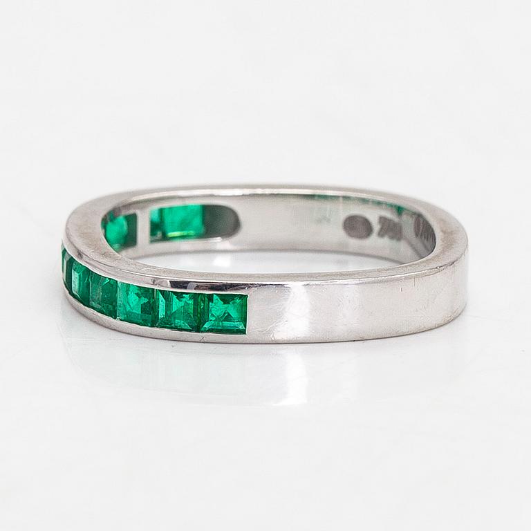 An 18K white gold eternity ring, with square-cut emeralds, Switzerland.