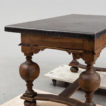 A 19th Century Baroque style table with a stone top.