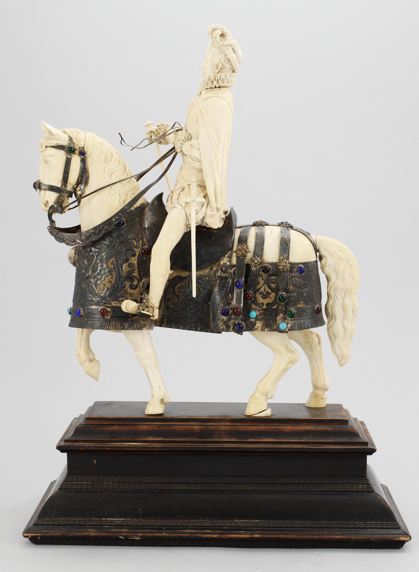 A late 19th century equestrian ivory, wood and metal statue.