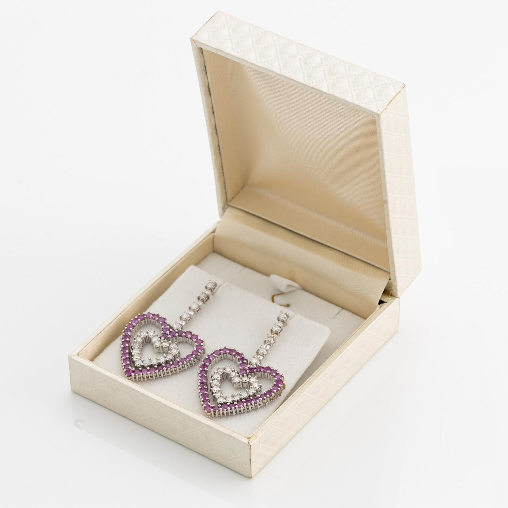 A pair of 18K gold earrings with round brilliant-cut diamonds and pink sapphires.