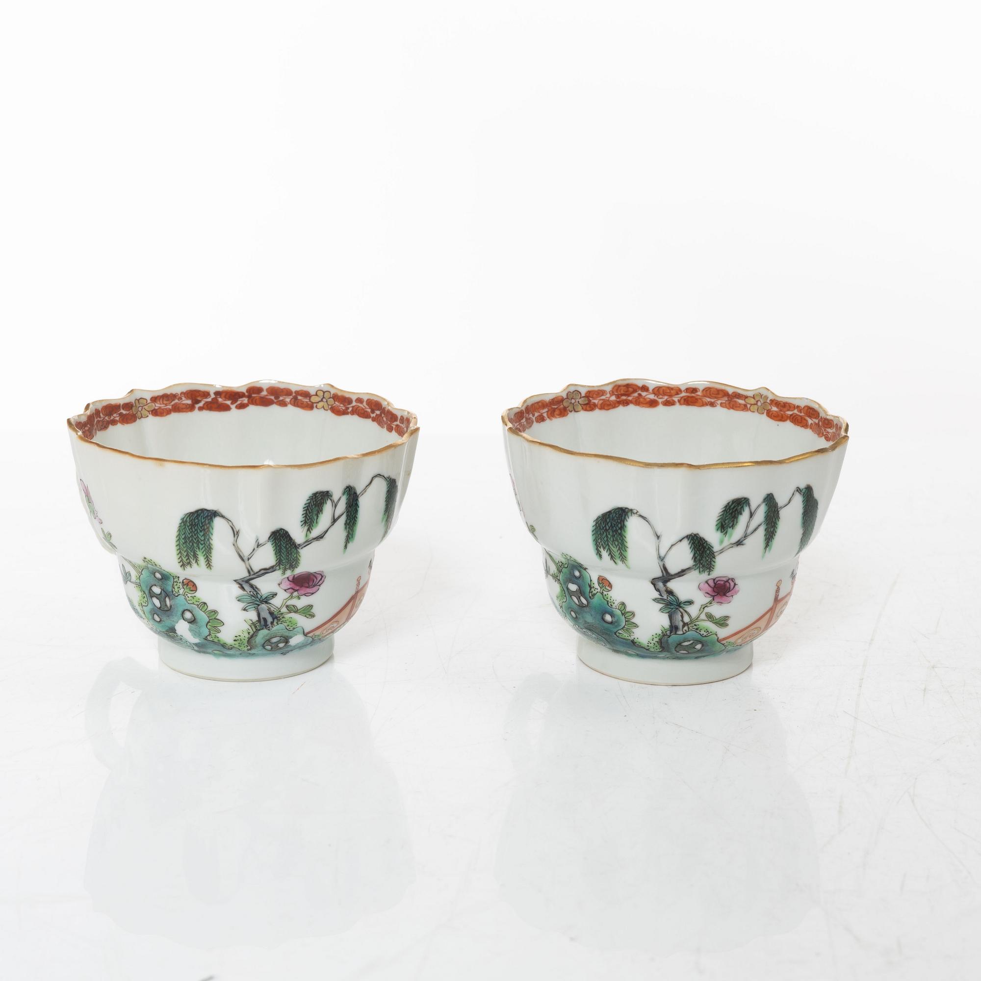 A pair of Chinese famille rose teacups with saucers and a pair of plates and two dishes, Qing dynasty, 18th century.