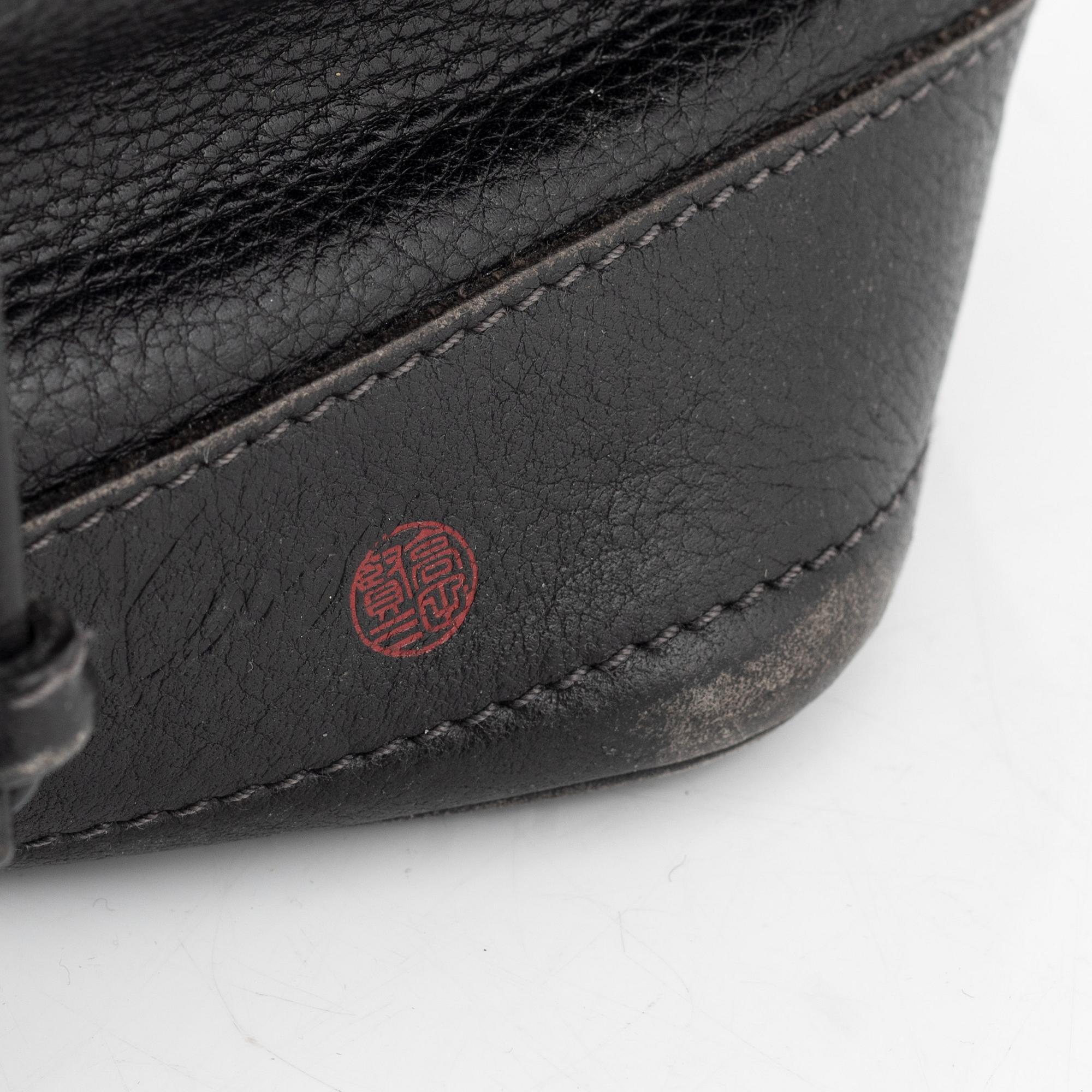 Kenzo, a black leather bucket bag.