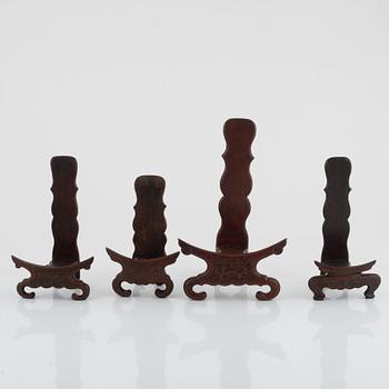 Seven hardwood stand for plates and vase, and one lid, China, 20th century.