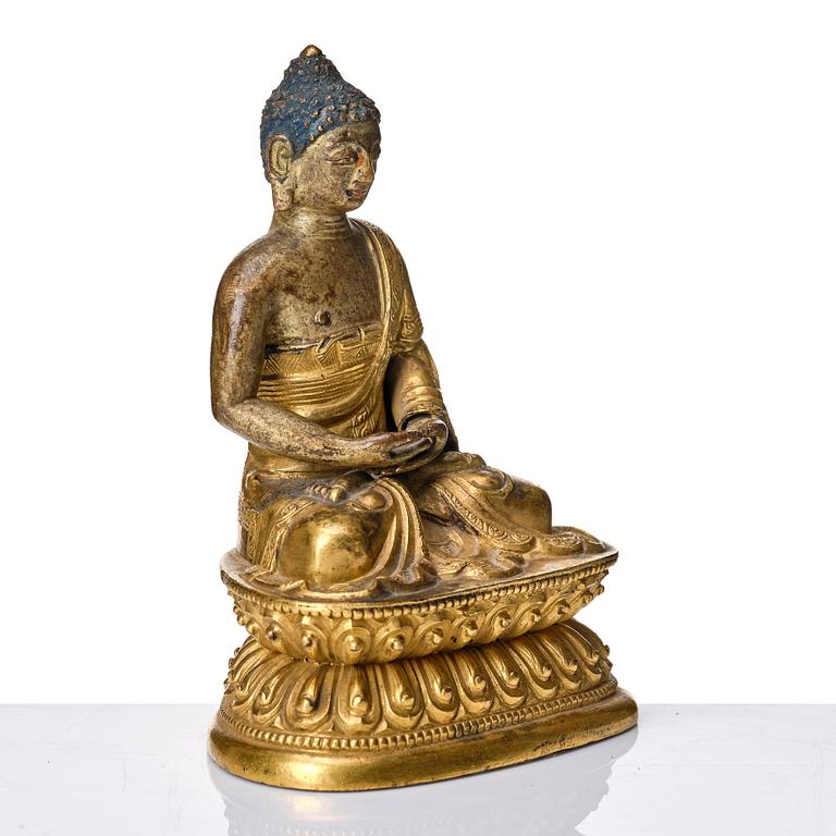 A gilt kopper alloy figure of buddha, Tibeto-Chinese, 18th Century.