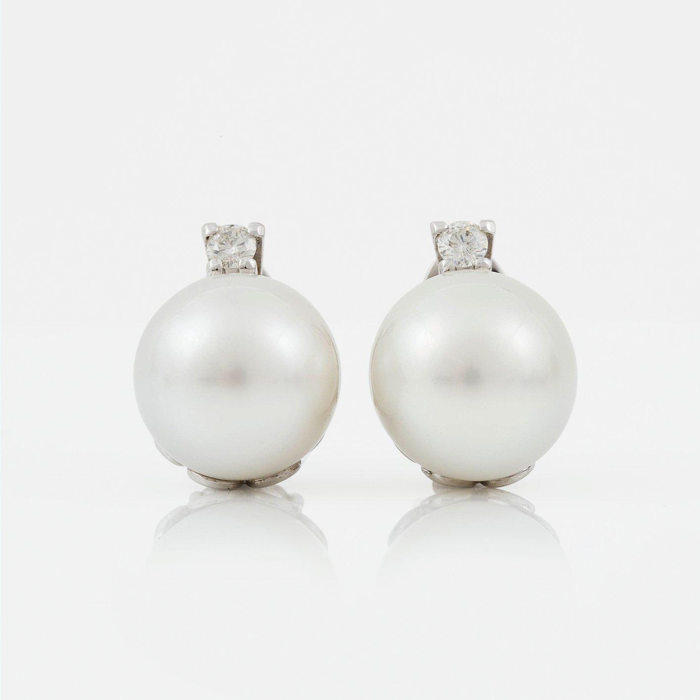 A pair of cultured South sea pearl and diamond earrings. Total carat weight of diamonds circa 0.35 ct.