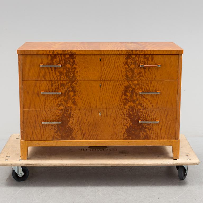 A 1930s art déco birch veneered chest of three drawers.