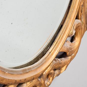 A gilded and bronzed woodcut leaf decorated mirror, second half of the 19th century.