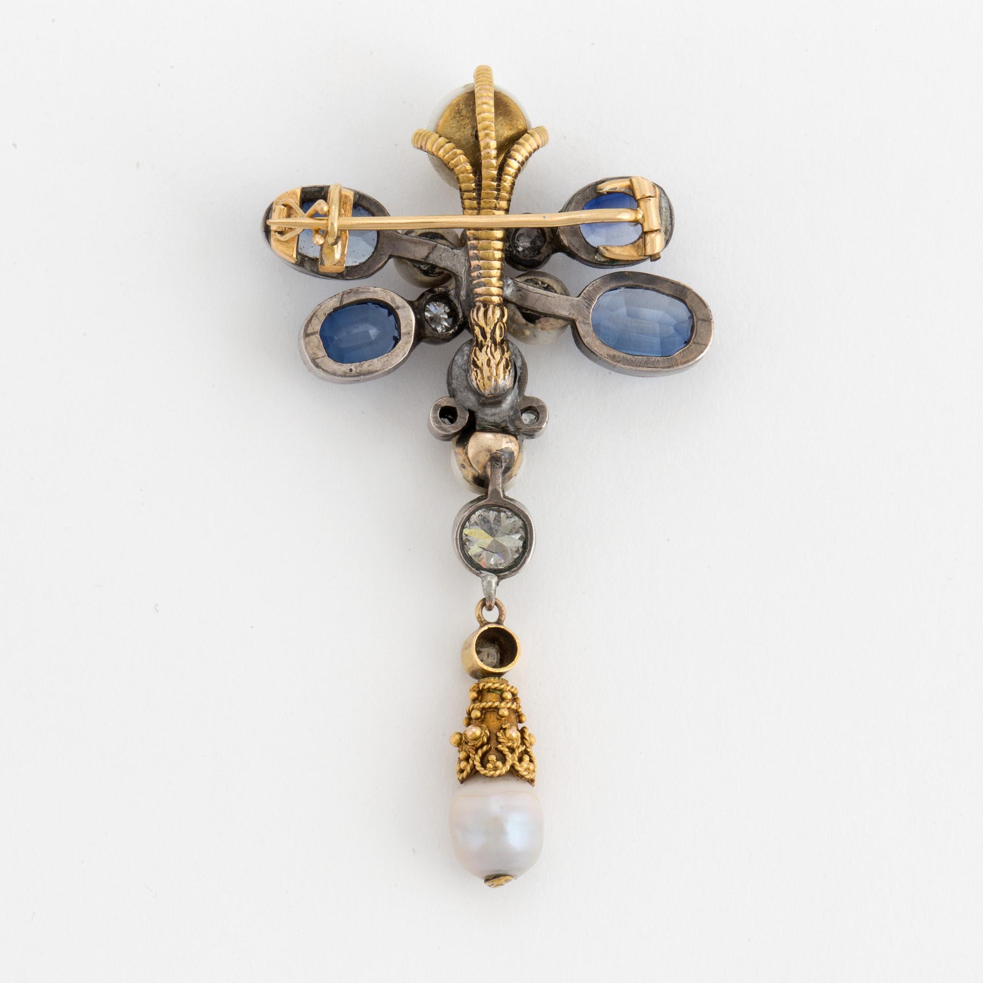 A brooch set with old-cut diamonds. fresh-water pearls and synthetic sapphires.