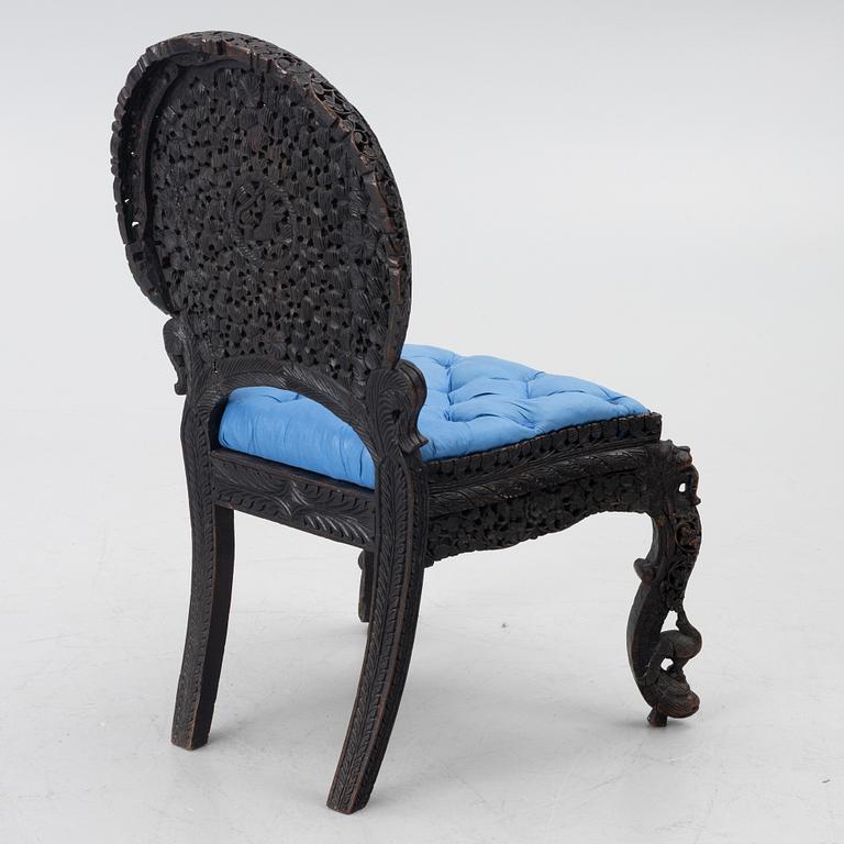 A carved 'blackwood' armchair.  bombay presidency circa 1880.