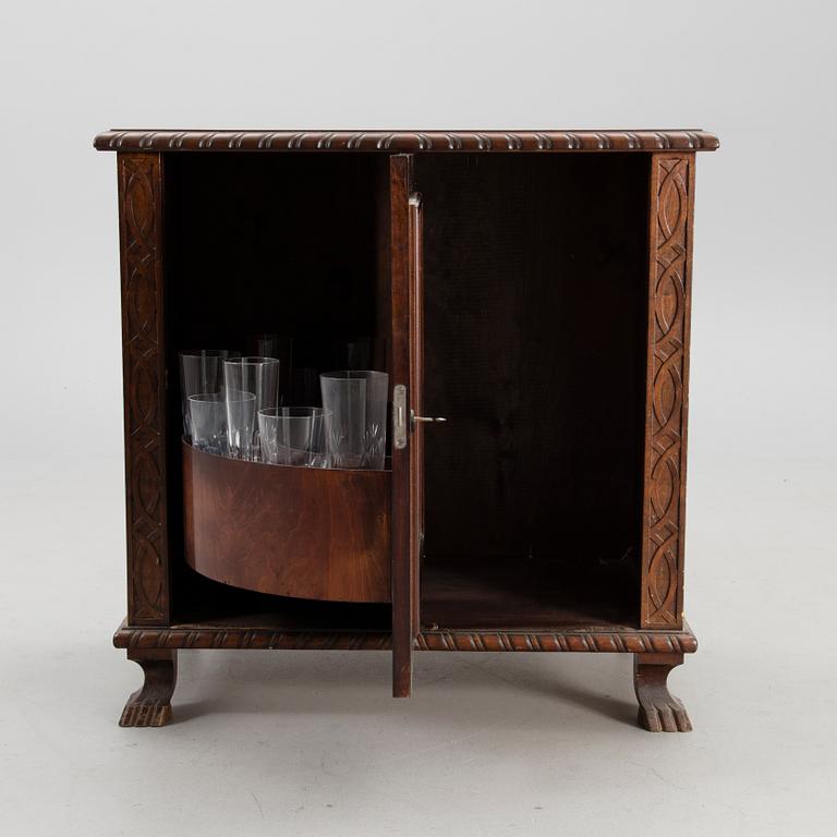 A WOODEN BAR CABINET.