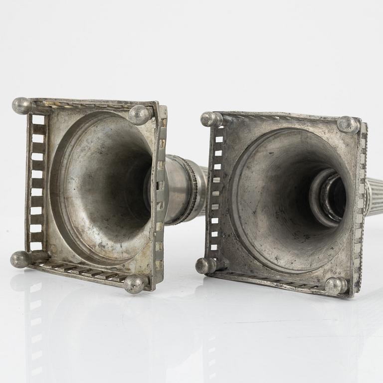 A matched pair of pewter candle sticks, 19th Century.